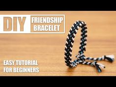 a black and white bracelet sitting on top of a wooden table with the words diy