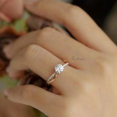 a woman's hand with a diamond ring on it