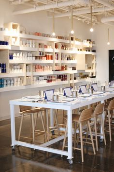 a long table with many chairs in front of it and shelves on the wall behind it