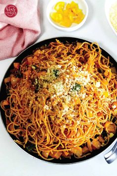 a pan filled with pasta and cheese next to other dishes