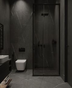 a black and white bathroom with a walk in shower