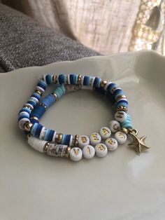 Ready for summer, this "Beach Vibes" bracelet set says it all!  Made with blue, white, and gray and tan speckled clay beads, gold plastic beads, white and gold plastic letter beads, complete with a gold plastic starfish charm.  On a stretchy elastic cord, this set fits most! Gold Beaded Bracelets With Letter Beads For Vacation, Clay Bead Inspiration, Beach Bracelets Clay Beads, Bracelets Clay Beads, Fun And Easy Diys, Clay Bracelets, Easy Diys, Beach Bracelet, Speckled Clay