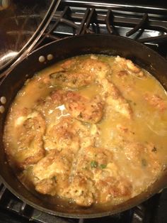 a pan filled with food sitting on top of a stove