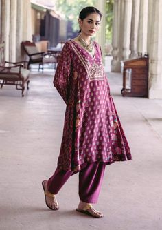 Editor's Note Presenting a plum mix-print kalidar kurta in luxurious dupion silk, adorned with a hand-embroidered yoke. This ensemble is perfectly paired with a chanderi silk solid salwar, creating a harmonious blend of prints and traditional elegance for a graceful and charming look. Fabric: Dupion silk pants: chanderi Color: Purple Components: Kurta and salwar Occasion: Festive Disclaimer: Product color may slightly vary due to photographic lighting sources or your monitor setting. Care: Dry c Kalidar Kurta Pattern, Blouse Yoke, Indian Designers, Kurta Patterns, Designer Store, Dupion Silk, Silk Pants, Mixing Prints, Indian Design