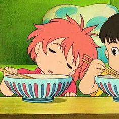 two children eating out of bowls with chopsticks