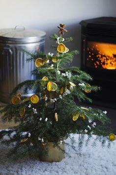 a small christmas tree sitting on top of a white rug