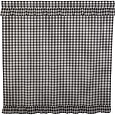 black and white checkered bedding with ruffles on the bottom, in front of a white background