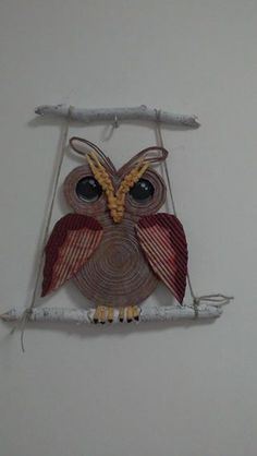 an owl is sitting on a branch and has eyes wide open as if it are holding onto a string