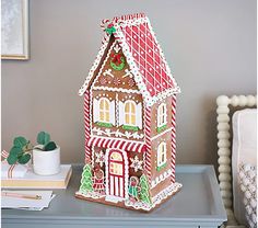 a gingerbread house is sitting on a table