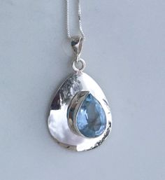 This is my newest design and unique from anything else on Etsy. Mid century modern style pendant. Solid Sterling Silver Necklace Chain Included. 21.8mm wide 10.7x15mm pear shaped Genuine Blue Topaz TCW Approx 8+ December Birthstone Blue Topaz Healing Properties.... Blue Topaz stones will heighten your ability to communicate better, and to express yourself in a meaningful way, both when speaking or when writing. It is a helpful stone if you have been having difficulties with public speaking. It m Blue Teardrop Pendant Jewelry With Large Stone, Blue Birthstone Jewelry For Mom, Blue Birthstone Jewelry Gift For Mom, Teardrop Aquamarine Necklace For Gift, Blue Teardrop Necklace With Large Stone, Teardrop Blue Topaz Necklace Gift, Light Blue Drop Jewelry For Gift, Topaz Jewelry With Large Stone For Gift, Teardrop Topaz Necklace For Gift