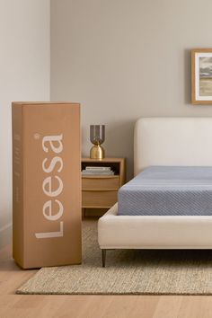 a bed with a box on the floor next to it