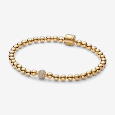 When you want to wear chunky and edgy beads with an elegant twist, choose the Beads & Pavé bracelet in our 14k gold-plated unique metal blend. The bracelet draws inspiration from the alternative looks of body piercings and punk styles with a polished, refined twist. It features a fully beaded chain with one slightly larger pavé-set bead and a barrel clasp. This Pandora bracelet can be worn alone or stacked with other styles in different metal finishes for an individual look. - Pandora Beads & Pavé Bracelet - 14k Gold-plated unique metal blend / Cubic Zirconia / Clear - Sz. 6.7 in Pandora Gold, Pave Bracelet, Pandora Beads, Bracelet Pandora, Body Piercings, Estilo Punk, Style Punk, Minimalist Bracelet, Gold Plated Bracelets