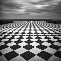 a black and white checkered floor with dark clouds in the background