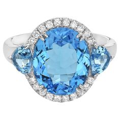 With this exquisite semi-precious swiss blue topaz ring, style and glamour are in the spotlight. This 14-karat oval cut ring is made from 3.4 grams of gold, 3 swiss blue topaz's totaling 6.62 karats, and is surrounded by 20 round SI1-SI2, GH color diamonds totaling 0.18 karats. This ring is a size 6.5. Clear Sunglasses Frames, Topaz Diamond Ring, Topaz And Diamond Ring, Stylish Watches Men, Clear Sunglasses, Swiss Blue Topaz Ring, Oval Cut Ring, Blue Fits, In The Spotlight