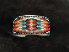 Authentic Beautiful handmade Navajo Hand Beaded Adult Cuffs Bracelets. Flexible 6.5" + 1" gap total 7.5" ❤️Made by 80 year old Grandma Mary Norris on Navajo Reservation Hand beaded cuffs. Present in virtually every Native American tribe, the feather symbol is universally recognized as a representation of trust, strength, wisdom, freedom, and honor. Incorporated into many sacred pieces of Native American wear, the feather is easily one of the most respected symbols. Southwestern Multicolor Cuff Bracelet For Festival, Multicolor Southwestern Cuff Bracelet For Festivals, Southwestern Style Multicolor Cuff Bracelet For Festival, Adjustable Multicolor Southwestern Cuff Bracelet, Southwestern Festival Cuff Bracelet With Round Beads, Southwestern Multicolor Adjustable Cuff Bracelet, Southwestern Style Multicolor Beaded Cuff Bracelet, Feather Symbol, Navajo Reservation