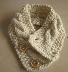 a white knitted scarf with buttons on it