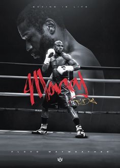 a man standing next to a boxing ring in front of a black and white photo