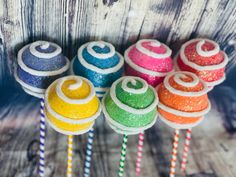 colorful lollipops with swirl designs on them are lined up in a row