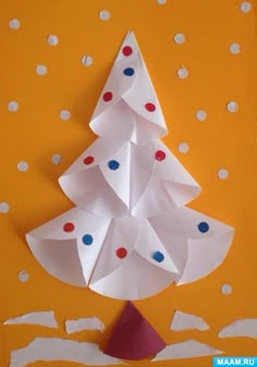 a paper christmas tree on an orange background