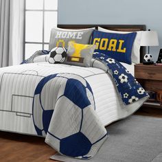 a soccer themed bed in a bedroom with blue and white decor on the headboard