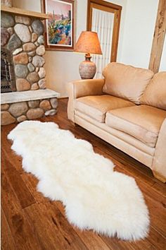 a living room filled with furniture and a fire place next to a stone fireplace mantel