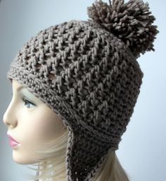 a mannequin head wearing a gray knitted hat