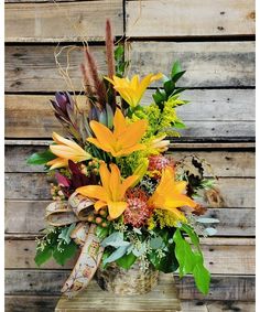 a vase filled with lots of different types of flowers