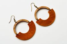 "A new twist on our Hope Hoops, these unique earrings feature genuine leather in your choice of autumn color. All hooks are lead and nickel free.  Earring measurements are from the top of the hook to the bottom of the earring.  Drop length is approximately 2 5/8\"." Handmade Brown Faux Leather Earrings, Handmade Brown Hoop Earrings For Everyday Wear, Everyday Handmade Brown Hoop Earrings, Handmade Leather Hoop Earrings, Everyday Brown Hoop Earrings With Ear Wire, Modern Brown Leather Earrings, Modern Orange Earrings For Everyday Wear, Trendy Brown Hoop Earrings For Everyday, Nickel-free Brown Hoop Earrings For Everyday