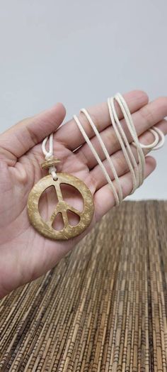 "Beige Color Peace Sign Necklace Coconut Shell Wooden Peace Pendant Peace Pendant Dimensions: 1.5\" Inch x 1.5\" Inch Adjustable Unisex Necklace. Pull the knots to adjust the necklace from 22\" Inches Up to 40\" Inches. Around the Neck. This necklace is for Womens, Mens, Teens Adjustable Cord - Fits Most Size. Wear this necklace short or long at anytime. FAST SHIPPING! Visit My Etsy Shop to see all of my handmade peace sign jewelry. To visit my Etsy Shop - Freedom Life Style Jewelry go to: https Bohemian Peace Sign Necklace For Gift, Adjustable Peace Sign Necklace, Adjustable Peace Sign Necklace As Gift, Vintage Jewelry With Peace Sign As Gift, Vintage Jewelry With Peace Sign For Gift, Vintage Peace Sign Jewelry Gift, Eco-friendly Adjustable Jewelry For Gift, Spiritual Peace Sign Necklace As A Gift, Peace Sign Jewelry For Gifts