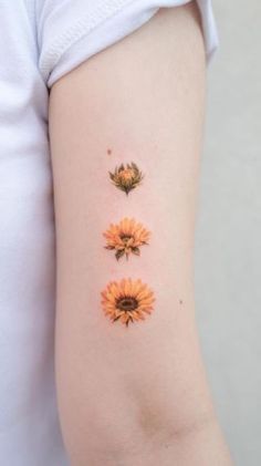 three sunflowers on the left side of the arm, and one is yellow