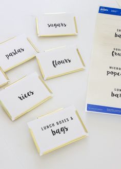 four place cards with the words lunch boxes and bags written in black ink on them