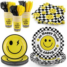 yellow and black party supplies including plates, cups, napkins and forks with smiley faces on them