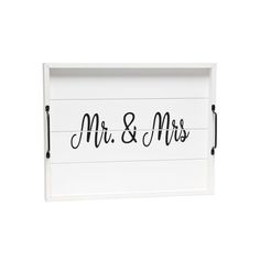 the mr and mrs wooden sign is hanging on a white wall with black stringing