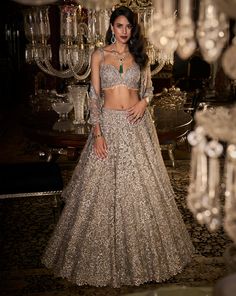 This lehenga set features three-dimensional embroidered in silver thread, sequin and bugle beads. The blouse shows crystal tassels at the waist. The fully embroidered dupatta shows crystal tassels on all four sides. DELIVERY TIMEPlease allow 8-12 weeks for your outfit to arrive. FABRIC DETAILSLehenga - Net / Dupatta - Net Professional cleaning only. Sequin Lehenga, Seema Gujral, Blouse Pictures, Gold Lehenga, Reception Outfit, Reception Lehenga, Full Sleeve Blouse, Net Lehenga, Pink Lehenga