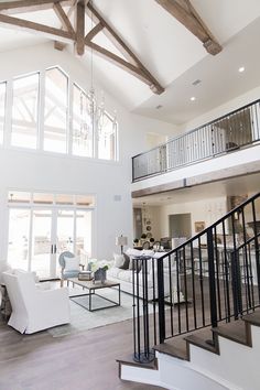 a living room filled with furniture and a staircase