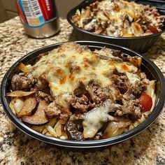 two bowls filled with food sitting on top of a counter