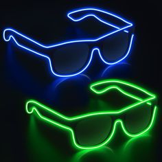 two neon glasses sitting next to each other on top of a black surface with one glowing in the dark