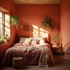 a bedroom with orange walls and plants on the bed, along with a wicker chair