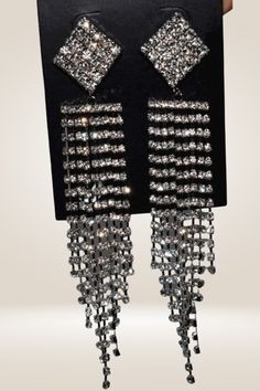 Rhinestone Chain Tassel Long Chandelier Drop Earrings Wear these earrings to make a statement. These Chandelier Drop Earrings are perfect for any occasion, whether it be a wedding, date night, or party. They are designed in an elegant chandelier style that cascades beautifully to look great with any dress style. The earrings are made with high-quality rhinestones and metal material that will give you years of wear and tons of compliments. Zinc Alloy Material Fairy Pattern Gold And Silver Detail Glamorous Metal Chandelier Earrings With Rhinestones, Glamorous Metal Chandelier Drop Earrings, Glamorous Silver Crystal Earrings With Rhinestone Fringe, Metal Tassel Drop Earrings For Party, Elegant Metal Earrings With Rhinestone Fringe, Elegant Metal Tassel Earrings For Party, Glamorous Metal Chandelier Earrings With Bling, Party Metal Chandelier Earrings With Rhinestones, Crystal Chandelier Earrings With Rhinestone Fringe