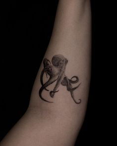 an octopus tattoo on the arm