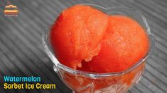 two orange ice creams in a clear bowl on a wooden table with the words watermelon sorbet ice cream