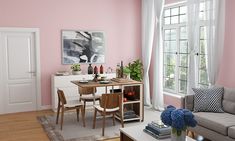 a living room filled with furniture and pink walls