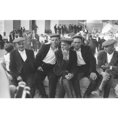 black and white photograph of men in suits sitting together