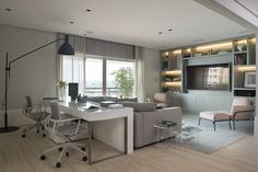 a living room filled with furniture and a flat screen tv mounted to the wall next to a window