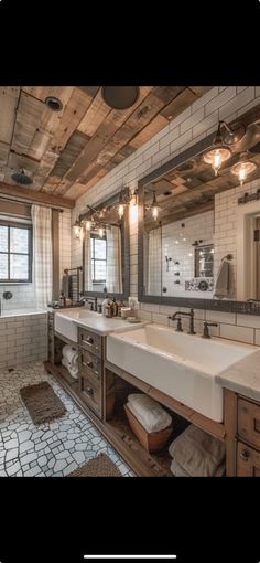 a large bathroom with two sinks and mirrors