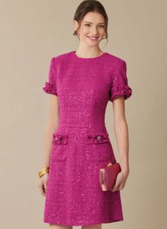 a woman in a bright pink dress is smiling