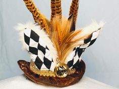 a close up of a hat with feathers on it