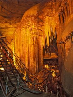 stairs leading up to an underground cave with stalate formations in the background stock photo