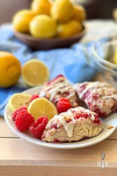 raspberry lemon scones on a white plate with fresh fruit in the background