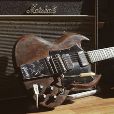 an electric guitar sitting on top of a wooden floor